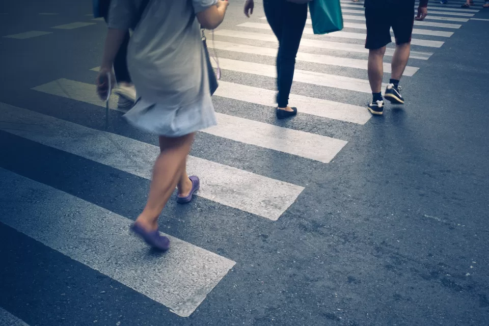 Close-up of the feet of pedestrians in a crosswalk